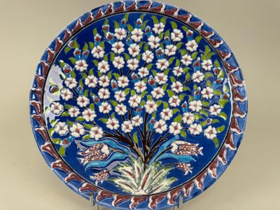 an image of a decorative plate with a tree of flowers on it