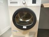 an image of a washing machine in the corner of a room