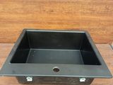 an image of a black sink sitting on top of a wooden floor