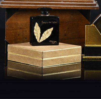 a bottle of perfume sitting on top of a wooden box