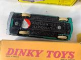 a box of dinky toys next to a toy car