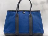 a blue and black handbag on a white background