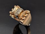 a close up of a gold ring on a black surface