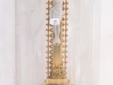 a gold cross under a glass dome on a table