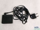 a black charger and a black power cord on a white surface