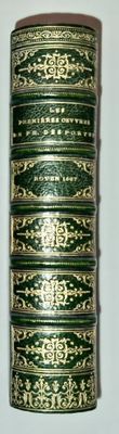 a close up of a roll of green and gold colored thread