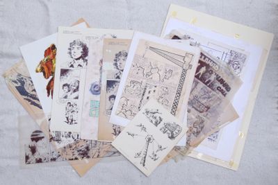 a pile of old postcards on a table
