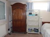 a bedroom with a bed and a bookcase in it