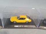 a yellow car in a display case on a table
