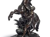 statue of a man on a horse with a woman on a horse