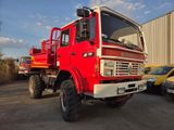 a large red truck that is parked in a parking lot