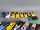 a lot of toy cars that are lined up on a table