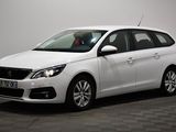 the small white car is parked in a room with a checkered floor