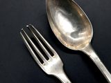 a fork and a spoon on a black surface