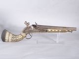 brass plated flintet pistol on clear acrylic stand on white background