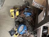 a pile of chains and tools on the floor of a garage