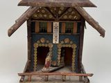 a small wooden house with a roof made of wood