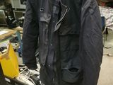 a black jacket and a yellow hat on a table