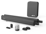 a close up of a black speaker with a remote and other accessories