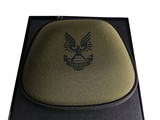a green hat with an eagle on it in a box