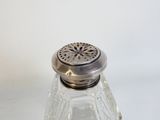 un salière et une poivrière en verre posées sur une table blanche