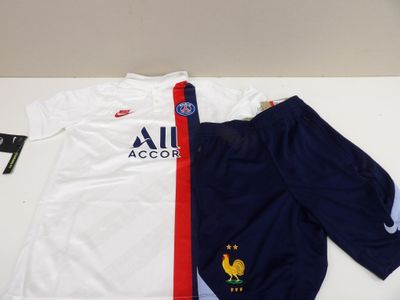 a white shirt and blue pants on a table