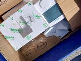 a cardboard box full of electronic equipment in a blue trash can