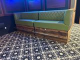 seating made from pallets and reclaimed wood with a green upholstered couch