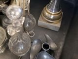 many silver objects on a table in a room