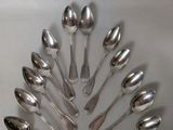 a lot of spoons arranged in a circle on the table