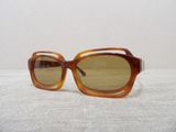 brown sunglasses with brown lenses on a white surface
