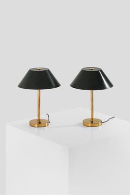 a pair of black lamps sitting on top of a white table