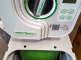 a green trash can sitting inside of a white trash can