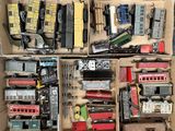 a lot of toy trains in a box on the floor