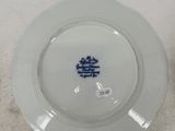 a white plate with a blue flower on it