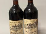 two bottles of wine sitting next to each other on a table