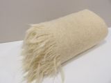 a roll of wool sitting on a table with a white background