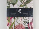 a white napkin with pink and green flowers on it