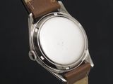 a close up of a watch with a brown strap