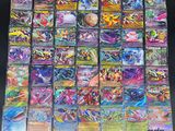 a large collection of pokemon cards sitting on top of a table