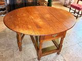 a wooden table with a drawer underneath it on a tile floor