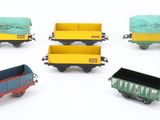 six toy trains that are sitting on a white surface