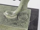 a statue of a person holding a dog on a base