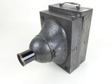 a close up of a metal object on a white surface