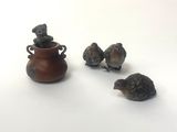 three birds that are sitting next to a vase
