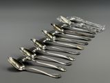 a group of silver spoons sitting on top of each other