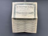an old french currency certificate hangs on a wall