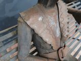 a statue of a woman sitting on a bench