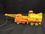 a toy truck with a crane attached to it ' s back
