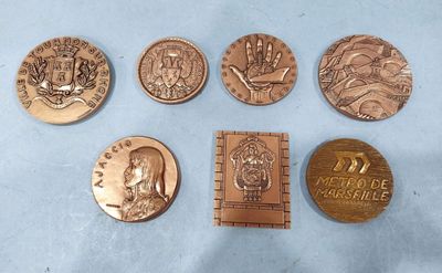 six different types of bronze coins on a blue surface